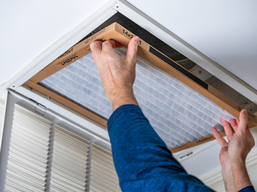 HVAC technician replacing a home air filter in Gardena
