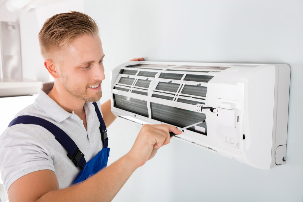HVAC technician maintaining a ductless air conditioner in Gardena