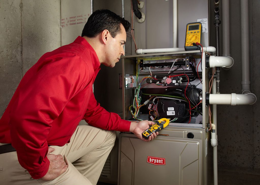 Heating technician diagnosing a furnace repair in Gardena