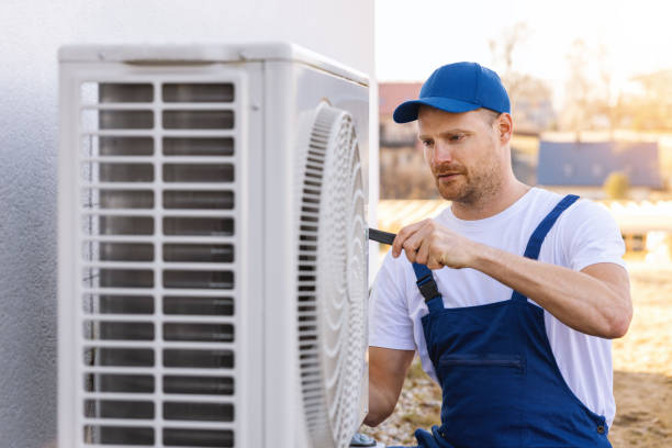 HVAC technician servicing an outdoor air conditioner in Gardena