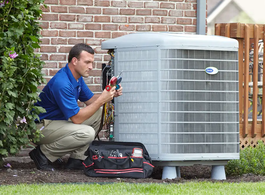 HVAC technician inspecting an outdoor AC unit in Gardena